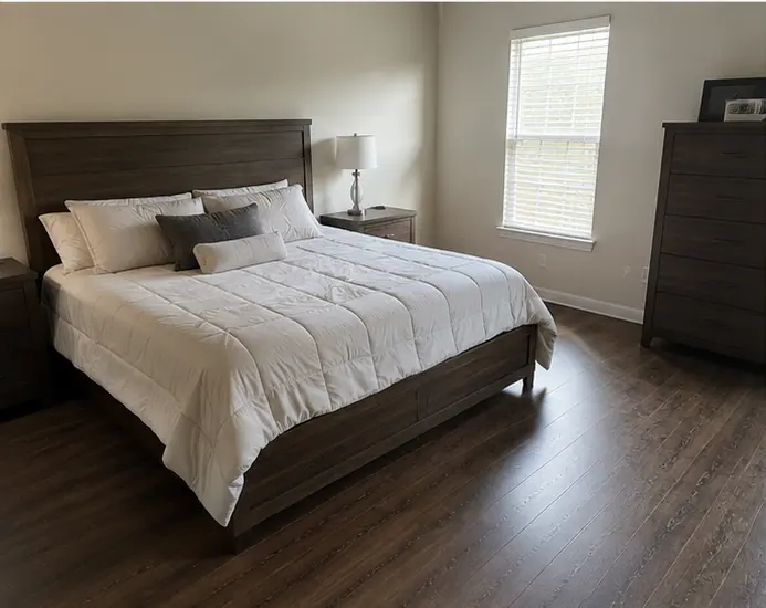 Clean, made bedroom in a Knox-Henderson apartment in Dallas