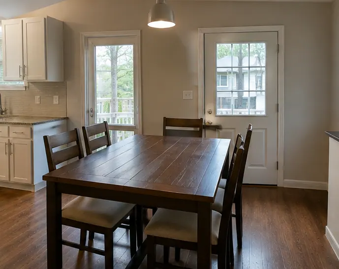 Clean dining room with wooden table and chairs set for service in a Dallas restaurant