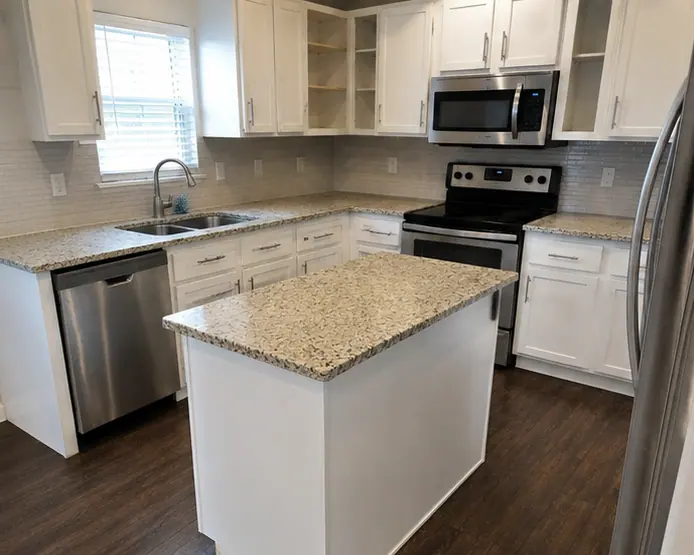 Clean apartment kitchen with island and stainless appliances in a Dallas rental
